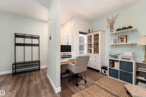 Dedicated office area featuring wood-finish flooring, light-colored walls, and a built-in wall partition - 1450 Darby Green, Edmonton, AB - Indoor Photo Showing Office