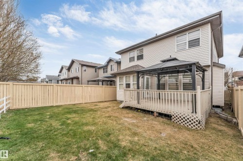 Expansive backyard featuring a wood privacy fence, a multi-level deck, and a detached gazebo - 3236 26 Avenue, Edmonton, AB - Outdoor With Deck Patio Veranda