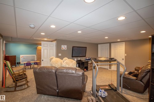Carpeted recreational room with recessed lighting and a drop ceiling - 5121 52 Ave, St. Paul Town, AB - Indoor