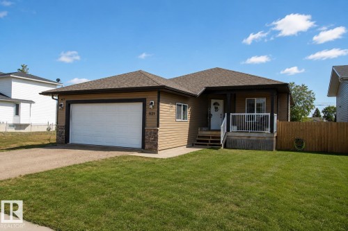Single-story residence featuring light brown horizontal siding with dark brown trim accents - 5121 52 Ave, St. Paul Town, AB - Outdoor With Exterior