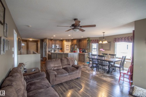 Expansive open-concept living space featuring wood-finish flooring, recessed lighting, and a ceiling fan with integrated light fixture - 5121 52 Ave, St. Paul Town, AB - Indoor Photo Showing Living Room