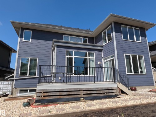 Multi-level dwelling with a modern facade and extensive fenestration - 4125 Kennedy Green, Edmonton, AB - Outdoor With Deck Patio Veranda