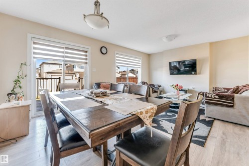 Bright open-concept living space with light-tone wood-finish flooring - 1715 27 Street, Edmonton, AB - Indoor Photo Showing Dining Room