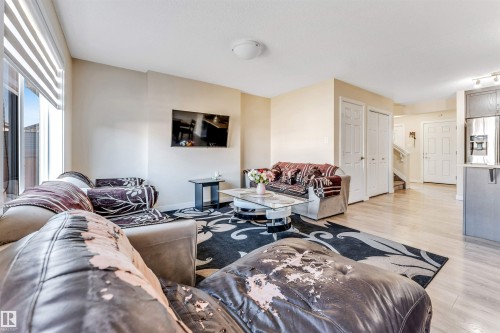 Spacious living area featuring light wood-finish flooring and neutral-toned walls - 1715 27 Street, Edmonton, AB - Indoor Photo Showing Living Room