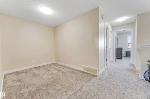 Interior room featuring light-colored walls and carpet flooring - 1715 27 Street, Edmonton, AB - Indoor Photo Showing Other Room