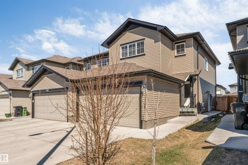 Contemporary two-story residence with a beige siding exterior and dark trim accents - 1715 27 Street, Edmonton, AB - Outdoor