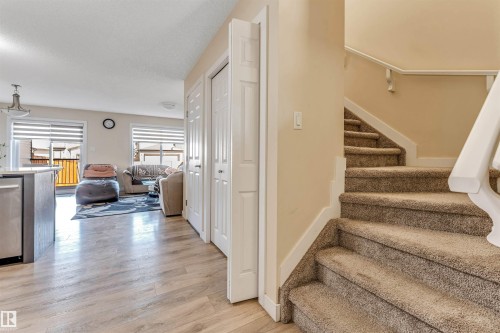 Carpeted staircase with white handrail, leading to an upper level - 1715 27 Street, Edmonton, AB - Indoor Photo Showing Other Room