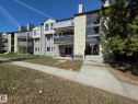 Multi-level building exterior featuring multiple private balconies with white railings, a prominent glass-paneled entry, and a mix of horizontal siding and stucco finishes - 304 34 Alpine Place, St. Albert, AB  - Outdoor With Balcony With Facade 