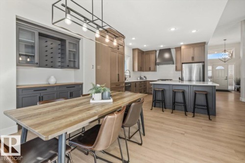 Open-concept kitchen and dining area featuring light wood-finish flooring - 7719 166 Avenue, Edmonton, AB - Indoor