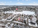 Aerial perspective of a residential neighborhood featuring detached homes and townhouses - 8312 29 Ave Nw, Edmonton, AB  - Outdoor With View 