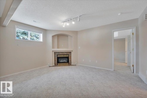 Featuring a gas fireplace and an arched alcove above the fireplace - 19 1203 Carter Crest Road, Edmonton, AB - Indoor With Fireplace
