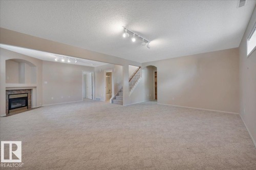 19 1203 Carter Crest Road, Edmonton, AB - Indoor Photo Showing Other Room With Fireplace