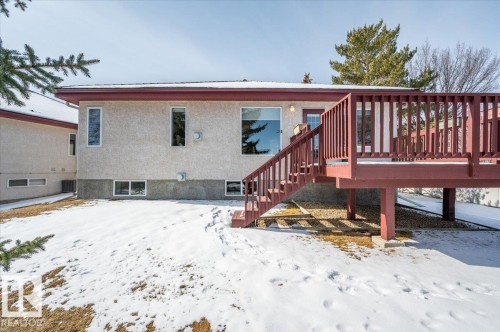 Features a large deck with stairs overlooking the common are with big trees - 19 1203 Carter Crest Road, Edmonton, AB - Outdoor With Deck Patio Veranda