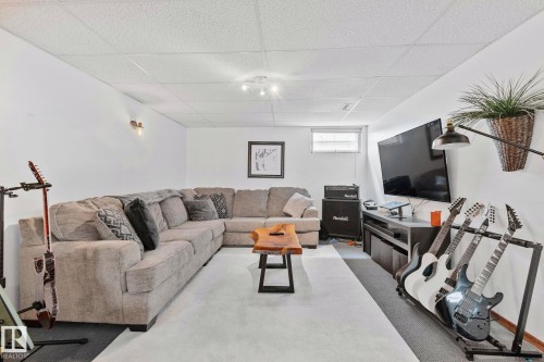 Lower-level living area with recessed lighting, a drop ceiling, and a high-mounted window - 13516 104A Street, Edmonton, AB - Indoor Photo Showing Other Room