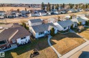 Single-story residence featuring a paved walkway, a well-maintained lawn, and mature landscaping - 13516 104A Street, Edmonton, AB  - Outdoor With View 