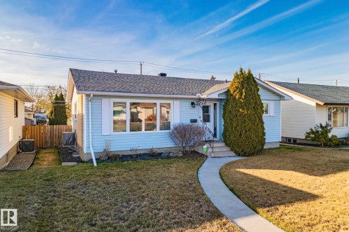 Light blue siding exterior featuring white trim and a contrasting dark gray shingle roof - 13516 104A Street, Edmonton, AB - Outdoor