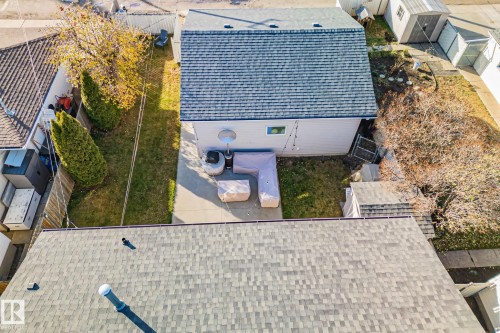 Private backyard featuring a concrete patio, established trees, and a detached structure - 13516 104A Street, Edmonton, AB - Outdoor