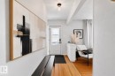 Entryway featuring wood-finish flooring, a white paneled front door with decorative glass, and a flush-mount ceiling light fixture - 13516 104A Street, Edmonton, AB  - Indoor Photo Showing Other Room 