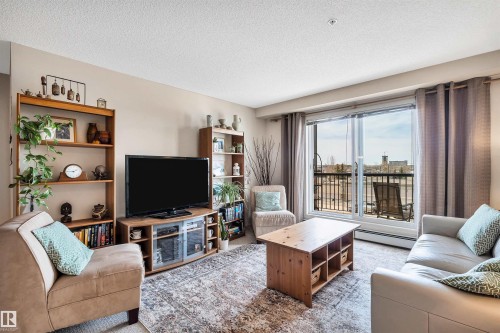 409 2430 Guardian Road, Edmonton, AB - Indoor Photo Showing Living Room