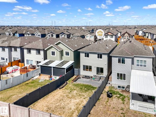 Rear exterior featuring a covered patio, a landscaped backyard, and a fenced perimeter - 2435 12 Avenue, Edmonton, AB - Outdoor