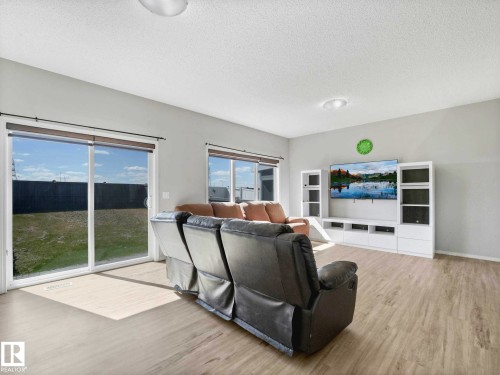 Living area featuring wood-finish flooring, light grey painted walls, and white ceiling - 2435 12 Avenue, Edmonton, AB - Indoor Photo Showing Living Room
