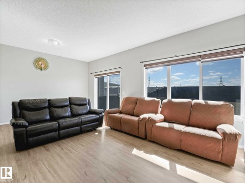 Spacious living area featuring light wood-finish flooring - 2435 12 Avenue, Edmonton, AB - Indoor Photo Showing Living Room