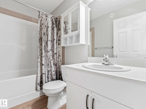 Bathroom vanity with an integrated sink, polished chrome faucet, and expansive countertop - 2435 12 Avenue, Edmonton, AB - Indoor Photo Showing Bathroom