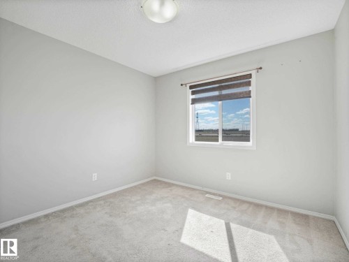 Light-filled interior space featuring neutral wall paint, white trim, and a white ceiling - 2435 12 Avenue, Edmonton, AB - Indoor Photo Showing Other Room