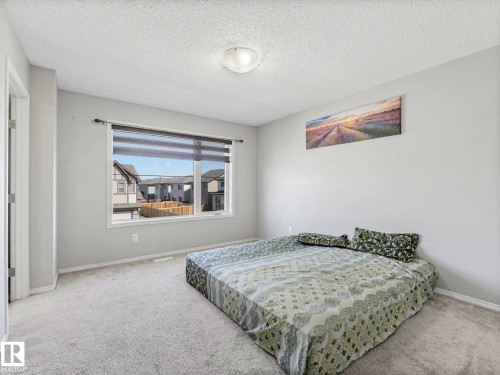 Carpeted interior space with a single window featuring blinds - 2435 12 Avenue, Edmonton, AB - Indoor Photo Showing Bedroom