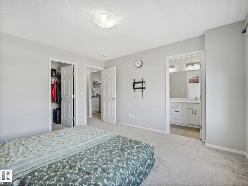 Bedroom with light gray walls and carpeting, featuring a flush-mount ceiling light - 2435 12 Avenue, Edmonton, AB - Indoor Photo Showing Bedroom