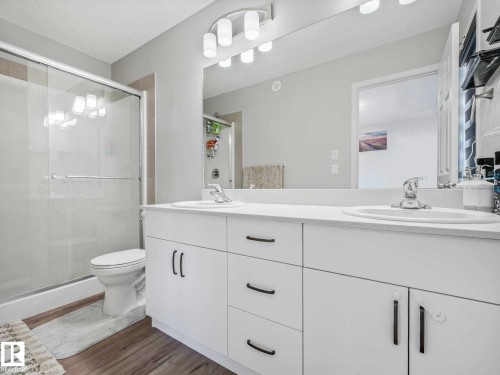 Double vanity with white cabinetry and integrated sinks - 2435 12 Avenue, Edmonton, AB - Indoor Photo Showing Bathroom