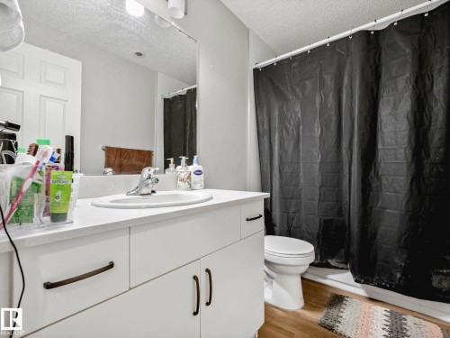 Bathroom featuring a white vanity with integrated sink, bronze-finish hardware, and a white countertop - 2435 12 Avenue, Edmonton, AB - Indoor Photo Showing Bathroom