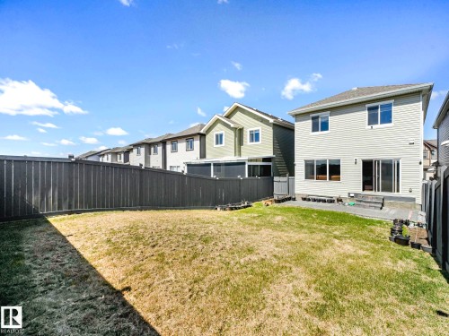 Expansive backyard with a manicured lawn, framed by a dark privacy fence - 2435 12 Avenue, Edmonton, AB - Outdoor