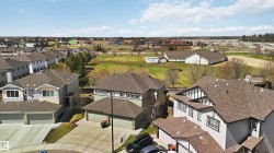 Residential property featuring a shingle roof and an attached garage - 