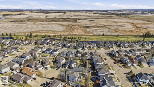 Aerial perspective of a developed residential area with numerous single-family homes - 5 Richelieu Place, Beaumont, AB - Outdoor With View