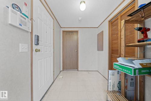 Entryway featuring a white paneled door, light-toned flooring, and warm wood trim - 623 Evergreen Park, Edmonton, AB - Indoor Photo Showing Other Room