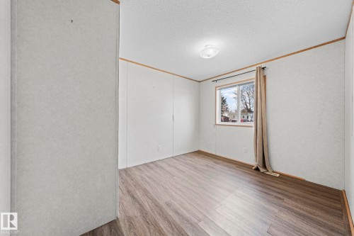 Bedroom featuring wood-finish flooring, a window with natural light, and a ceiling-mounted light fixture - 623 Evergreen Park, Edmonton, AB - Indoor Photo Showing Other Room