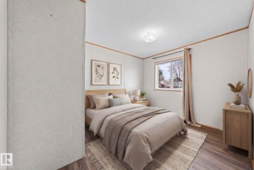 Room featuring wood-finish flooring, a window with natural light, a ceiling-mounted light fixture, and horizontal wall paneling with wood trim accents - 623 Evergreen Park, Edmonton, AB - Indoor Photo Showing Bedroom