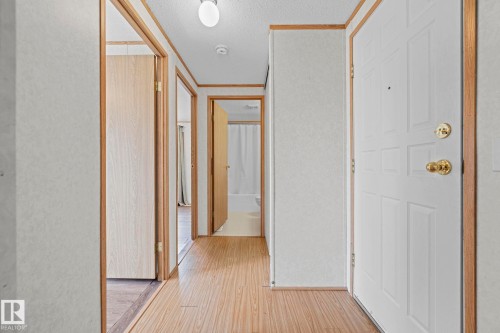 Hallway with wood-finish flooring, white walls, and wood trim - 623 Evergreen Park, Edmonton, AB - Indoor Photo Showing Other Room
