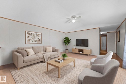 Spacious living area featuring light wood-finish flooring, a vaulted ceiling, and a ceiling fan with integrated lighting - 623 Evergreen Park, Edmonton, AB - Indoor Photo Showing Living Room