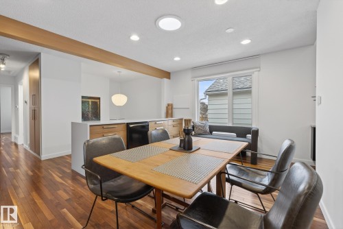 Inviting dining area featuring hardwood floors, a light wood dining table, and recessed lighting - 9736 78 Avenue, Edmonton, AB - Indoor Photo Showing Dining Room
