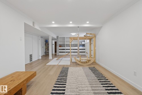 The property features light wood flooring, white walls, and recessed lighting - 9736 78 Avenue, Edmonton, AB - Indoor Photo Showing Other Room