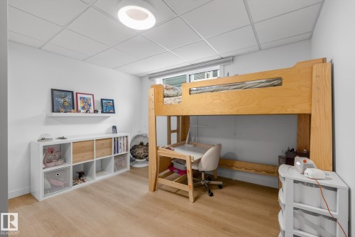 This room features light wood flooring, a white ceiling with recessed lighting, and a window providing natural light - 9736 78 Avenue, Edmonton, AB - Indoor Photo Showing Office