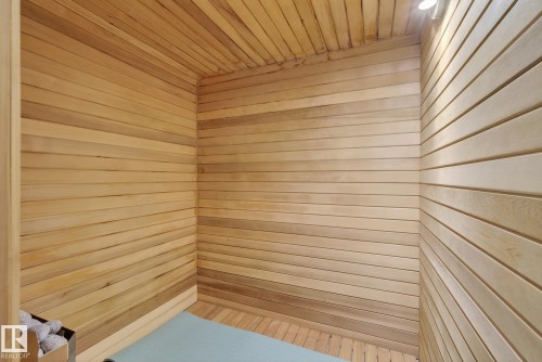 Interior space featuring light-colored wood paneling on the walls and ceiling, with a contrasting light blue floor - 9736 78 Avenue, Edmonton, AB - Outdoor With Exterior