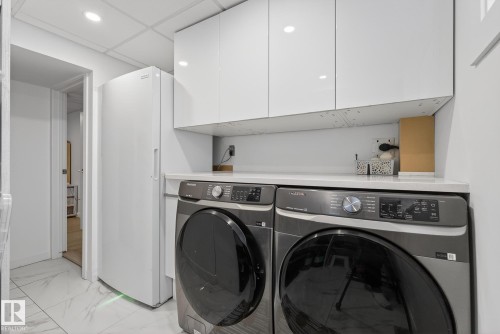 Laundry area featuring white cabinetry, a countertop, and recessed lighting - 9736 78 Avenue, Edmonton, AB - Indoor Photo Showing Laundry Room