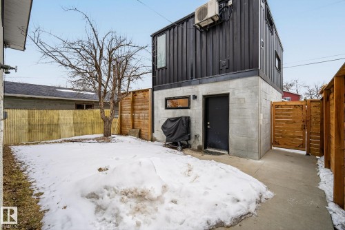 The property features a concrete foundation and a dark corrugated exterior - 9736 78 Avenue, Edmonton, AB - Outdoor With Exterior