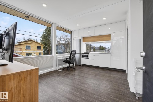 This versatile space features wide plank flooring, large windows providing abundant natural light, and recessed lighting - 9736 78 Avenue, Edmonton, AB - Indoor