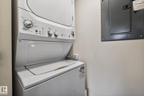 The property includes a stacked washer and dryer unit - 9736 78 Avenue, Edmonton, AB - Indoor Photo Showing Laundry Room