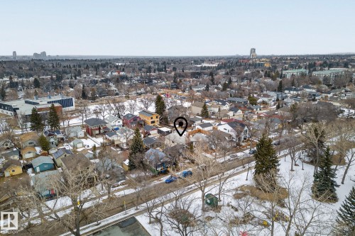Aerial view of the surrounding neighborhood, featuring residential properties, mature trees, and visible roads - 9736 78 Avenue, Edmonton, AB - Outdoor With View