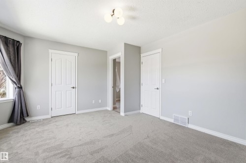Neutral-toned carpeting throughout - 8730 92A Avenue, Edmonton, AB - Indoor Photo Showing Other Room